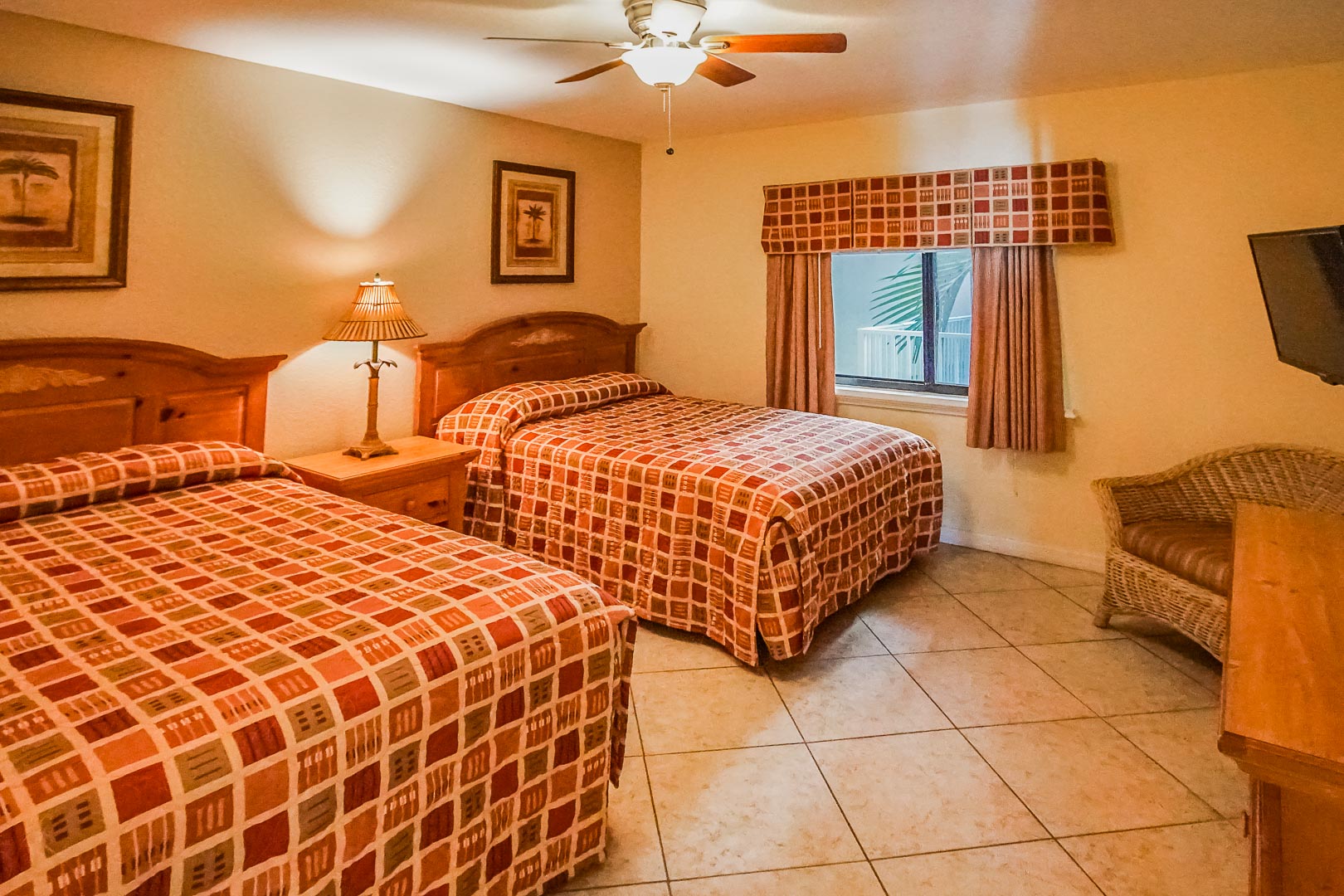 A bedroom with double beds at VRI's Sand Pebble Resort in Treasure Island, Florida.